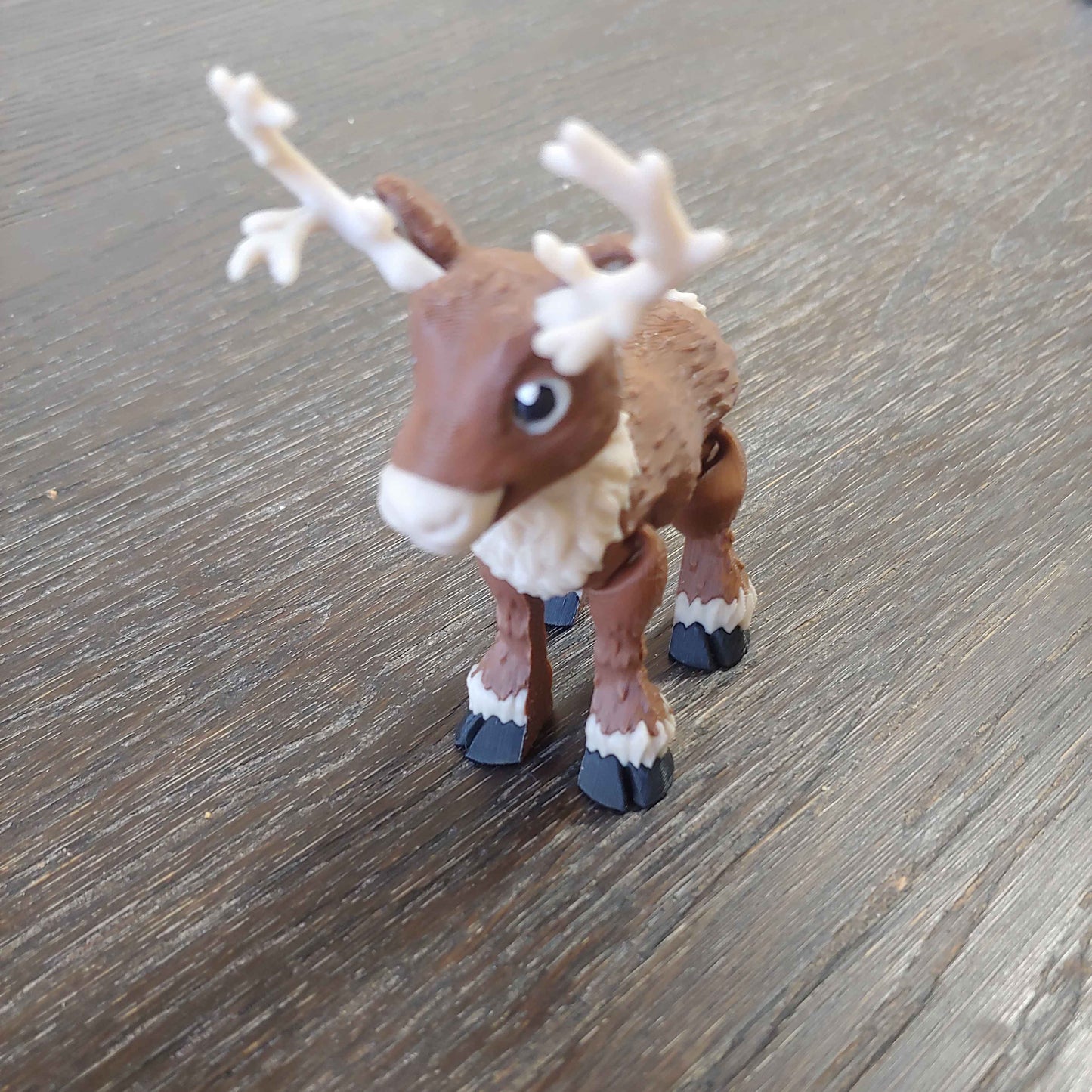 Small reindeer figurine on a wooden surface